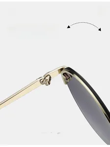 Detailed close-up of a durable golden metal hinge on these oval UV400 sunglasses