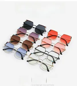 Flat lay of geometric cat-eye sunglasses in various colors with slim metal temples