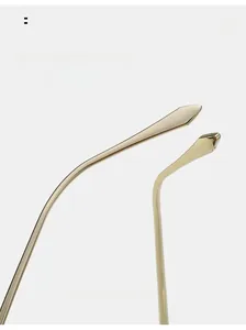 Detail of curved golden metal temples with ergonomic arc for comfortable sunglasses wear