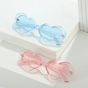 Chic heart-shaped sunglasses in light blue and pink on white geometric steps