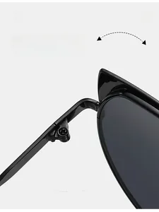 Macro detail of a durable metal hinge on irregular black sunglasses for women