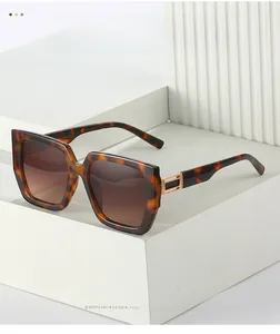 Detail of tortoise shell square sunglasses with gold metal hollow temple design