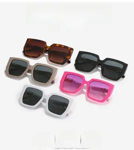 Flat lay of square oversized sunglasses in five colors with wide frames and metal accents