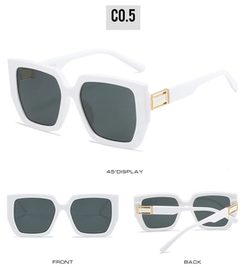 Macro detail of white square frames with gold metal accents and dark grey lenses