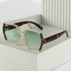 Oversized geometric sunglasses with tortoise shell frame and translucent green lenses