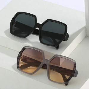 Oversized geometric polygon sunglasses in black and translucent grey with gradient lenses