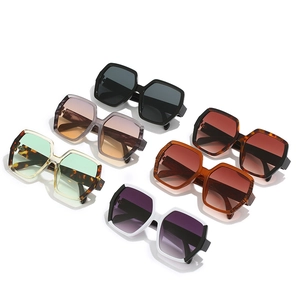 Multiple pairs of geometric oversized sunglasses in various colors on a white background