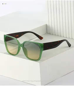Detail of green transparent square sunglasses with tortoiseshell temples and UV400 marking