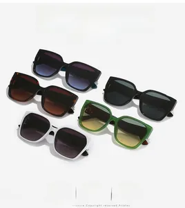 Flat lay of square oversized sunglasses in black, white, green, and tortoise shell colors
