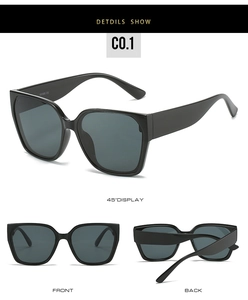Detail view of black square sunglasses with UV400 CE protection markings and grey lenses