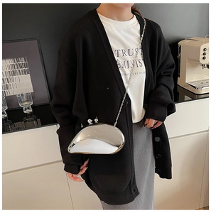 Modern metallic irregular bean-shaped crossbody bag with silver chain on model