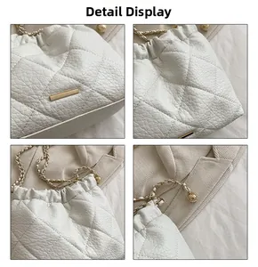Detail display of white quilted leather bag with elegant gold chain strap and hardware