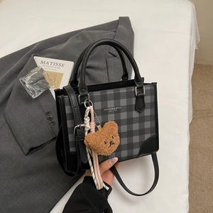 Minimalist black plaid square handbag with plush bear charm and leather handles