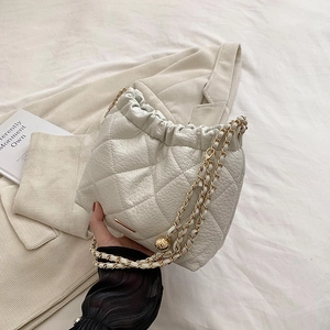 White quilted chain shoulder bag with drawstring closure and gold metal ball charms