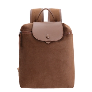 Minimalist brown canvas backpack with adjustable straps and faux leather flap on white background