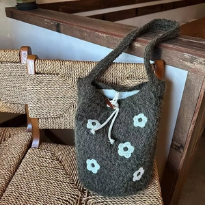 Deep grey plush shoulder bag with white flower embroidery and drawstring wood button
