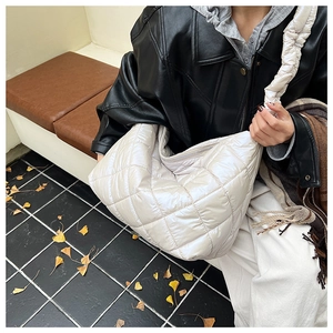 Detailed view of white quilted hobo bag featuring large capacity and diamond stitch nylon