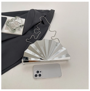 Silver fan-shaped sequin clutch bag with metal chain shown next to a smartphone for scale