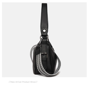 Side view of black pebble leather shoulder bag featuring a geometric woven strap