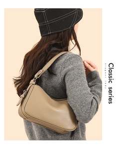 Side view of khaki leather shoulder bag with lychee grain texture on a female model