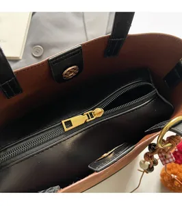 Detail of internal zipper pocket and golden magnetic buckle on vintage tote bag