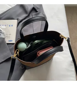 Detailed interior of color-block tote bag showing large capacity for daily essentials