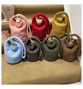Detailed arrangement of plush bucket bags in seven vibrant colors on carpeted steps