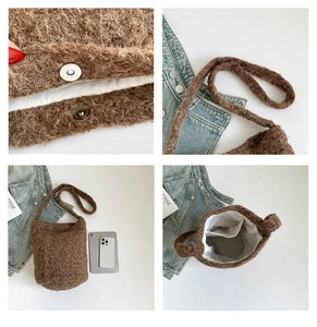 Detail view of plush bucket bag showing magnetic closure and internal storage pocket