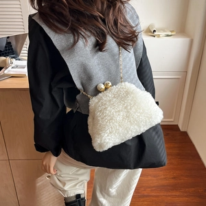 Detail of white plush crossbody bag with gold chain strap and bead clasp closure