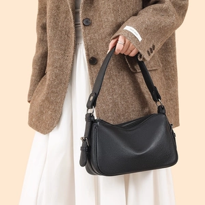 Classic black leather underarm shoulder bag with wide strap on model in vintage style