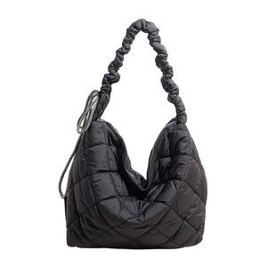 Fashionable black quilted puffer shoulder bag with ruffled handle and diamond pattern