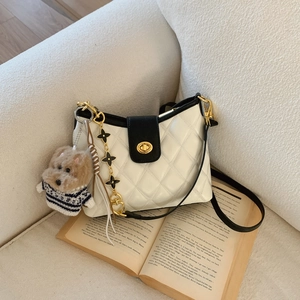 Chic white quilted shoulder bag with black contrast flap and golden turn-lock closure