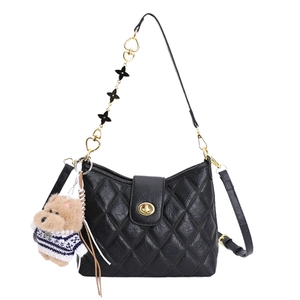 Quilted black crossbody bag with gold lock, decorative heart chain, and cute puppy charm