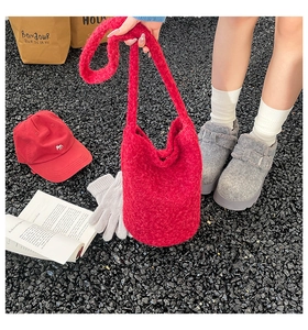 Detail of red plush bucket bag with fuzzy texture and matching casual winter accessories
