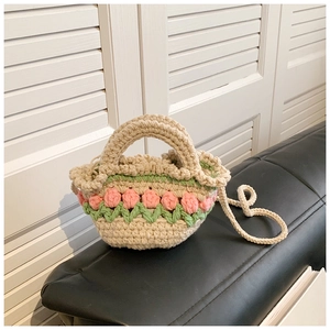 Detail of crochet beach bag featuring 3D pink tulip decor and woven texture