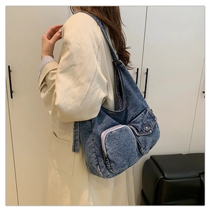 Retro washed denim tote bag with functional pockets and stitch detail on wide shoulder strap