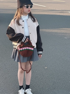 Detail of child's hand-crocheted brown bag with 3D pink flowers in a street style view
