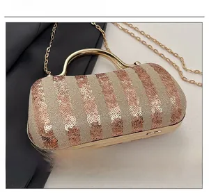 Detailed macro view of champagne gold evening bag with sequins and metal chain strap