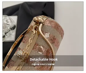 Macro detail of champagne sequin mesh evening bag with removable crystal ball hook