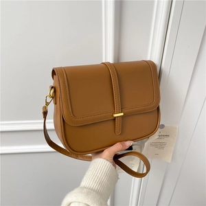 Minimalist caramel brown square crossbody bag with gold buckle and adjustable strap
