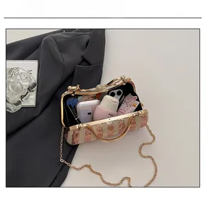 Detail showing internal capacity of gold sequin evening clutch bag with chain strap