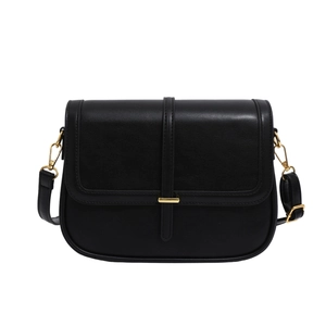 Minimalist black leather crossbody bag with golden buckle and adjustable strap