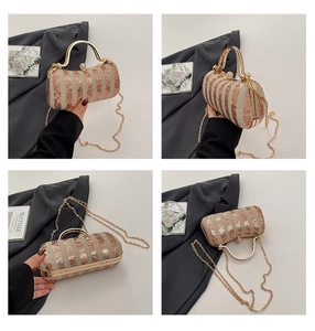 Detail view of rose gold sequined evening bag with gold handle and pearl clasp clasp