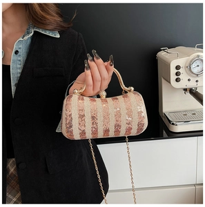 Detail of champagne gold sequined evening bag with pearl clasp and metal chain