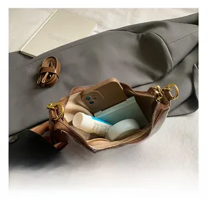 Detail showing internal capacity of the brown crocodile pattern hobo bag with daily items