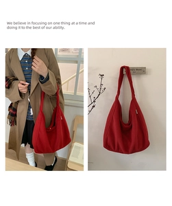 Detail of red corduroy tote bag showing textured material and slouchy retro design