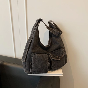 Retro washed denim shoulder bag in dark grey with functional front pockets and wide strap