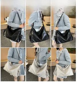 Detail view of large soft leather tote bag with pleated Hobo style and side ribbons