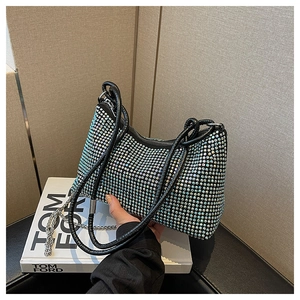 Detail of elegant black handbag with shimmering silver rhinestones and chain strap