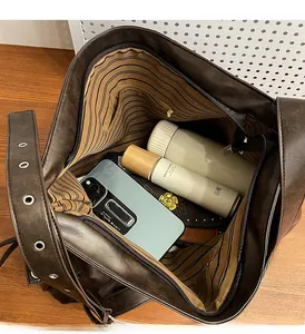 Detailed interior of vintage brown tote bag with striped lining and large capacity storage